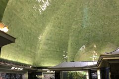 Green glass tiles evoke an underwater atmosphere.